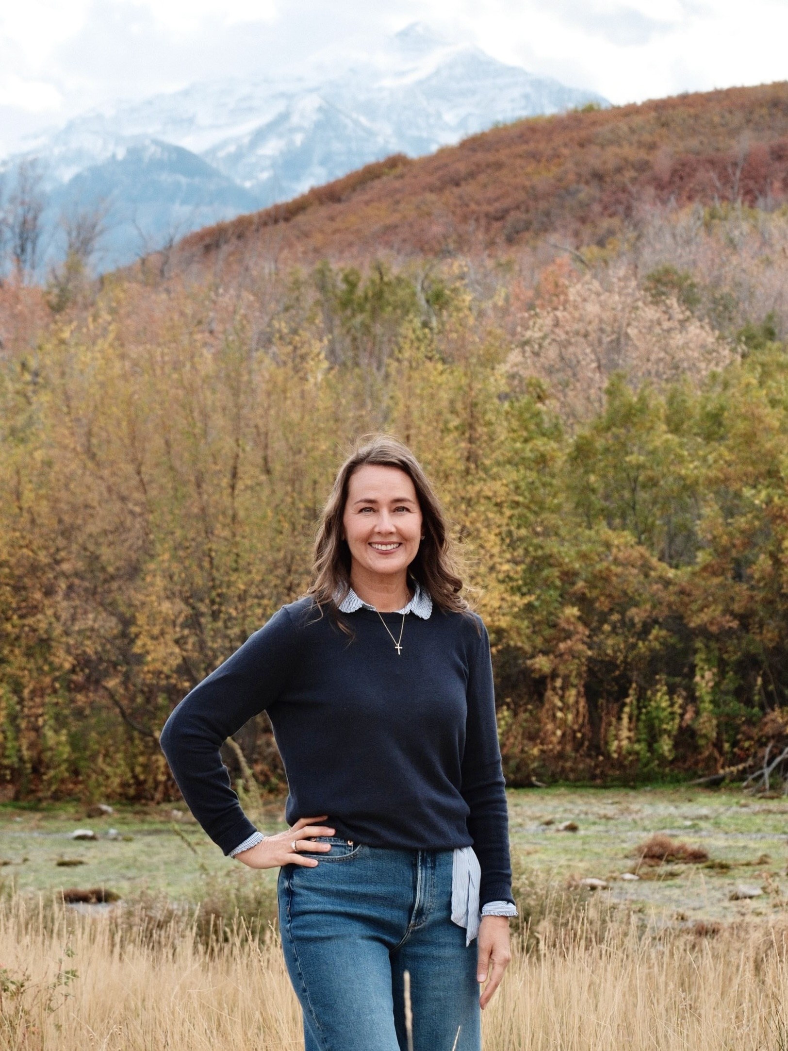 Tara Saar M.Ed., founder of Elevar Tutoring and reading and dyslexia intervention specialist, standing in a mountain field in Utah.